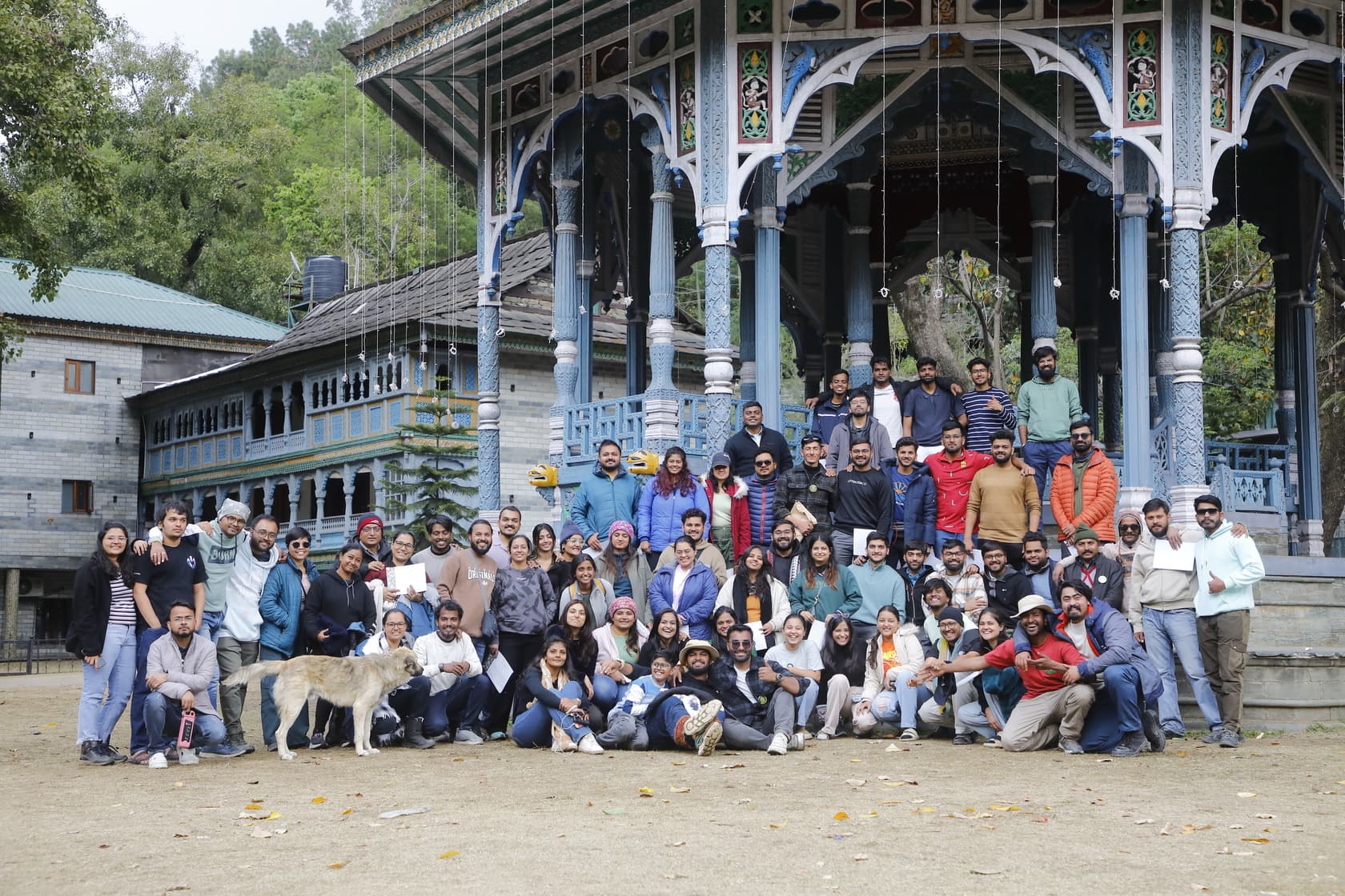 Large travel group gathered outside a heritage building - Image 2